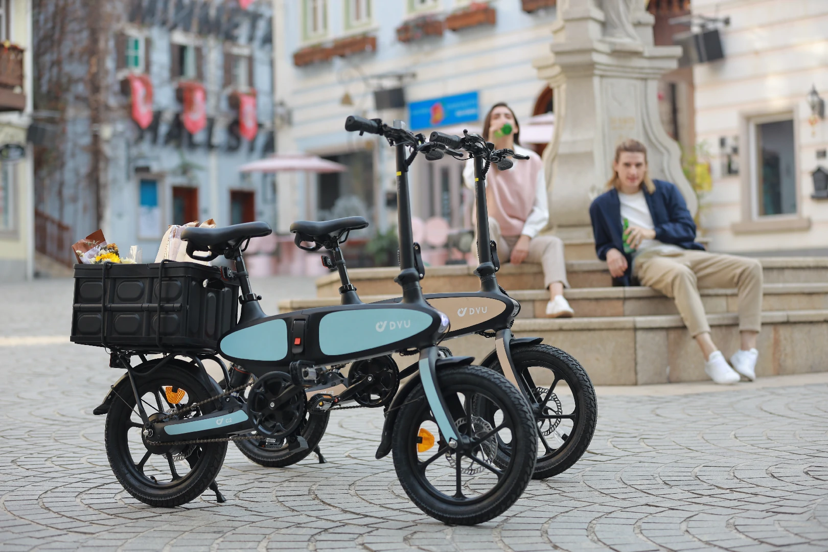 DYU C2 folding e-bikes parked in an outdoor city storage area