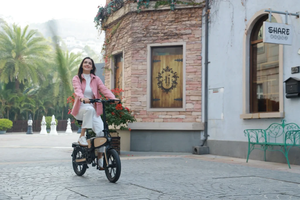 DYU C2 woman riding past brick buildings in a European city