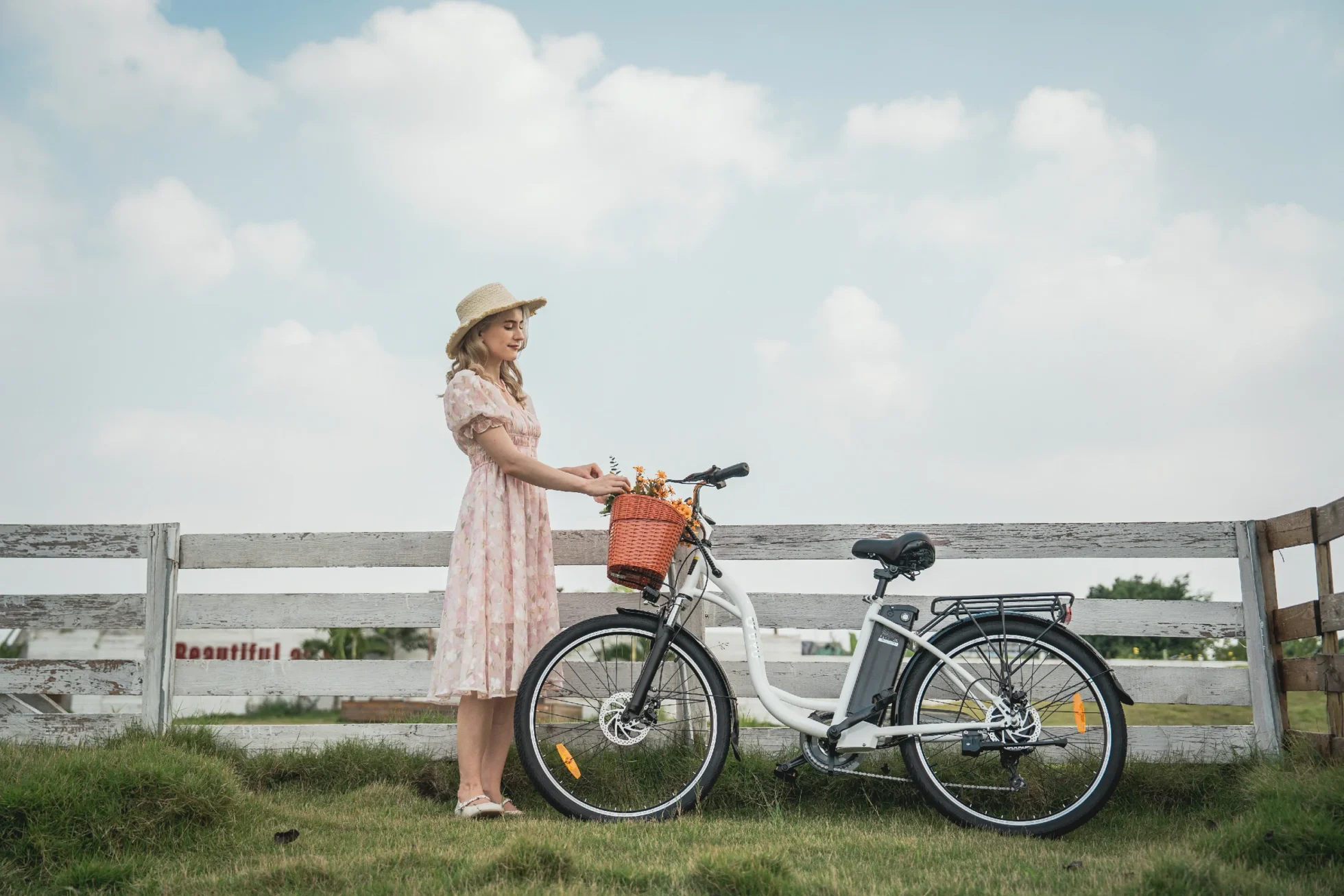 DYU C6 electric city bike riding beside a waterside fence