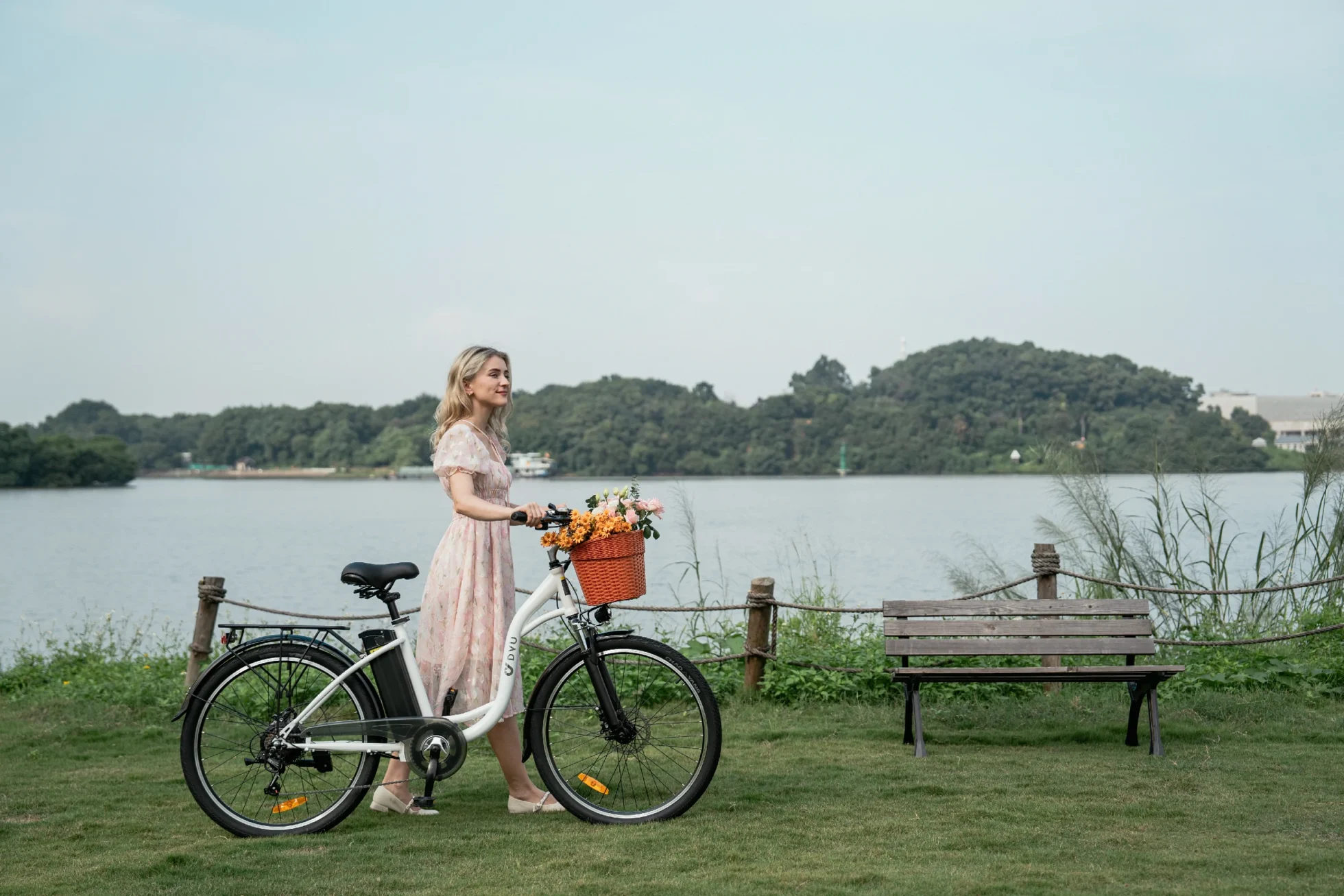 DYU C6 electric bike parked by a lake bench