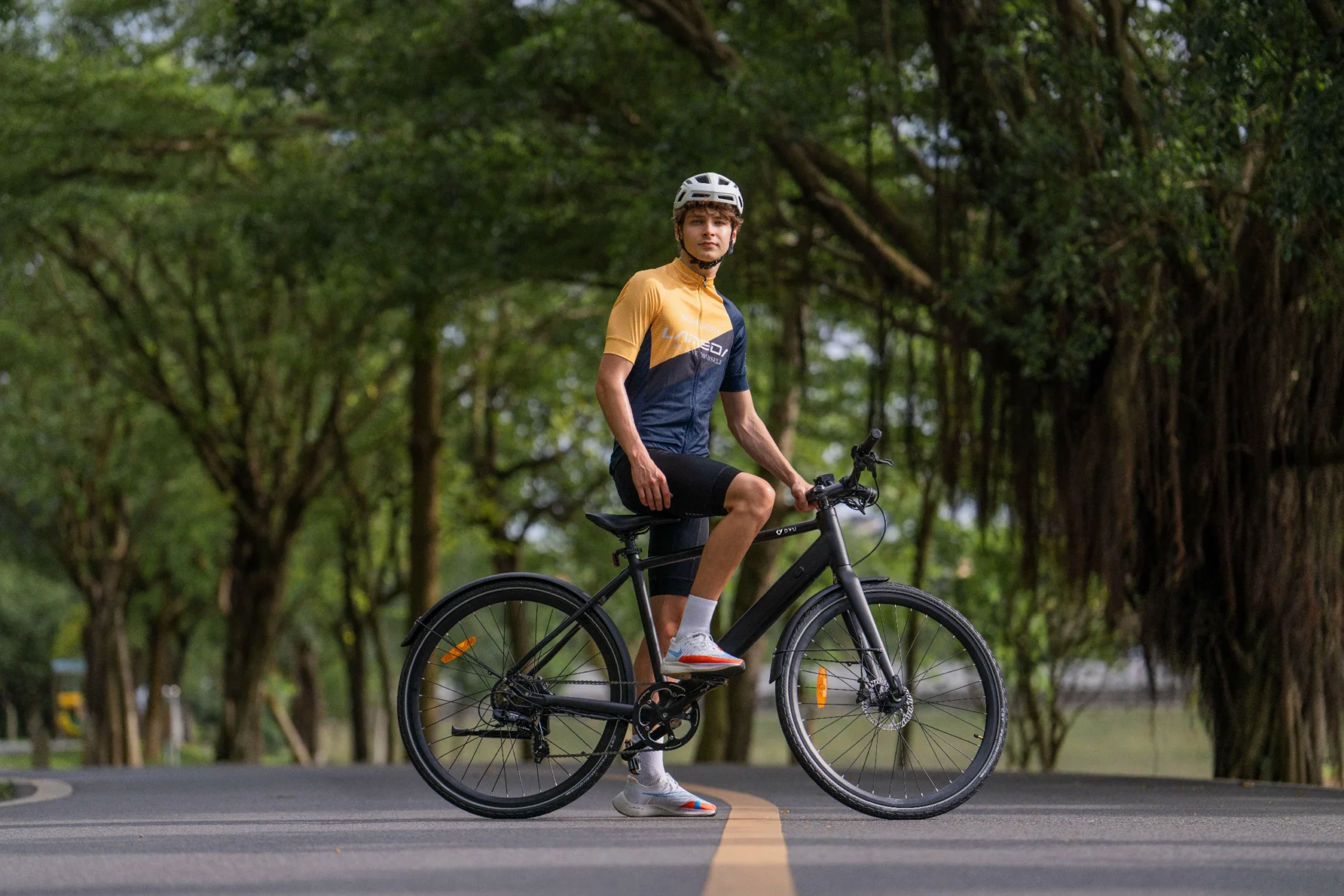DYU Stroll 1 parked on a tree-lined street beside a compact puncture repair kit