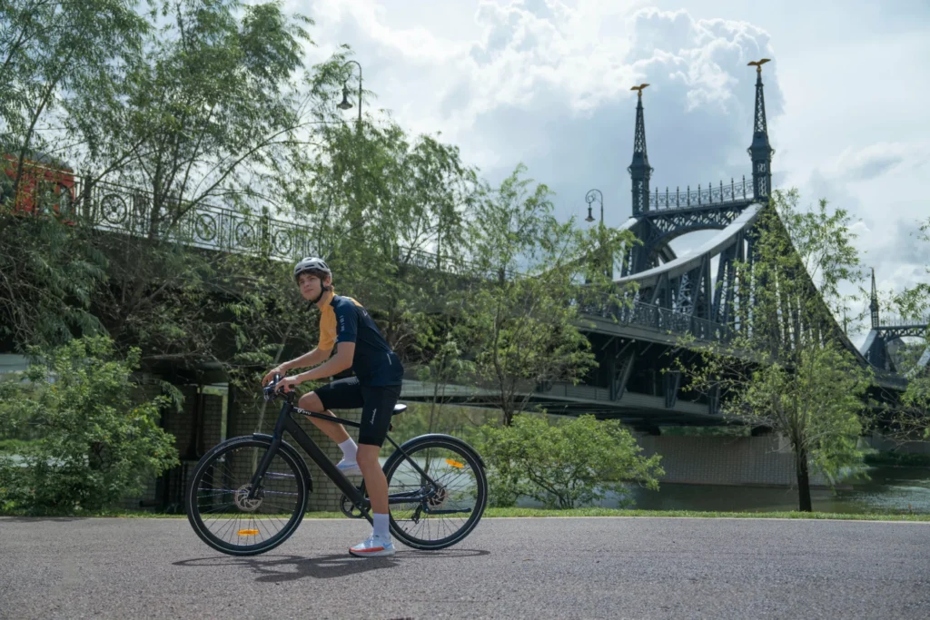 DYU Stroll 1 rider standing near a river bridge before a city comfort setup ride