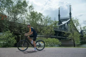 DYU Stroll 1 rider standing near a river bridge before a city comfort setup ride