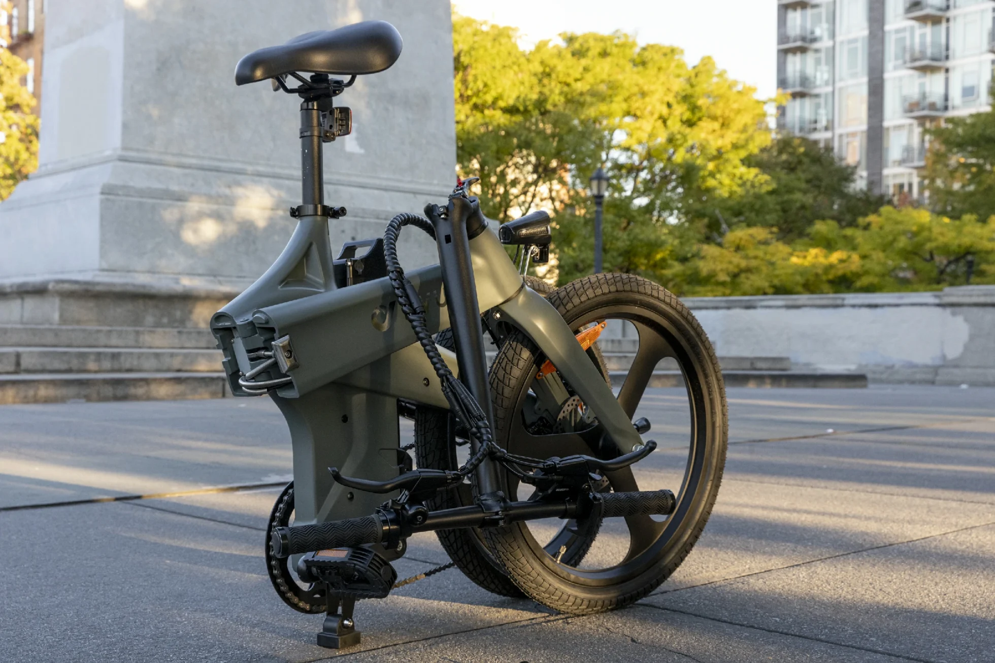 Folding e-bike parked in an urban plaza during a student lock routine