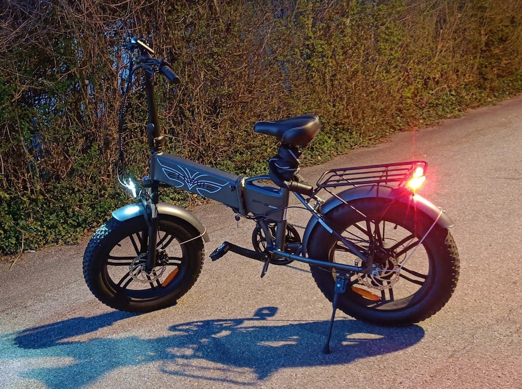 ENGWE EP-2 Boost fat tire folding e-bike parked on a road with lights on