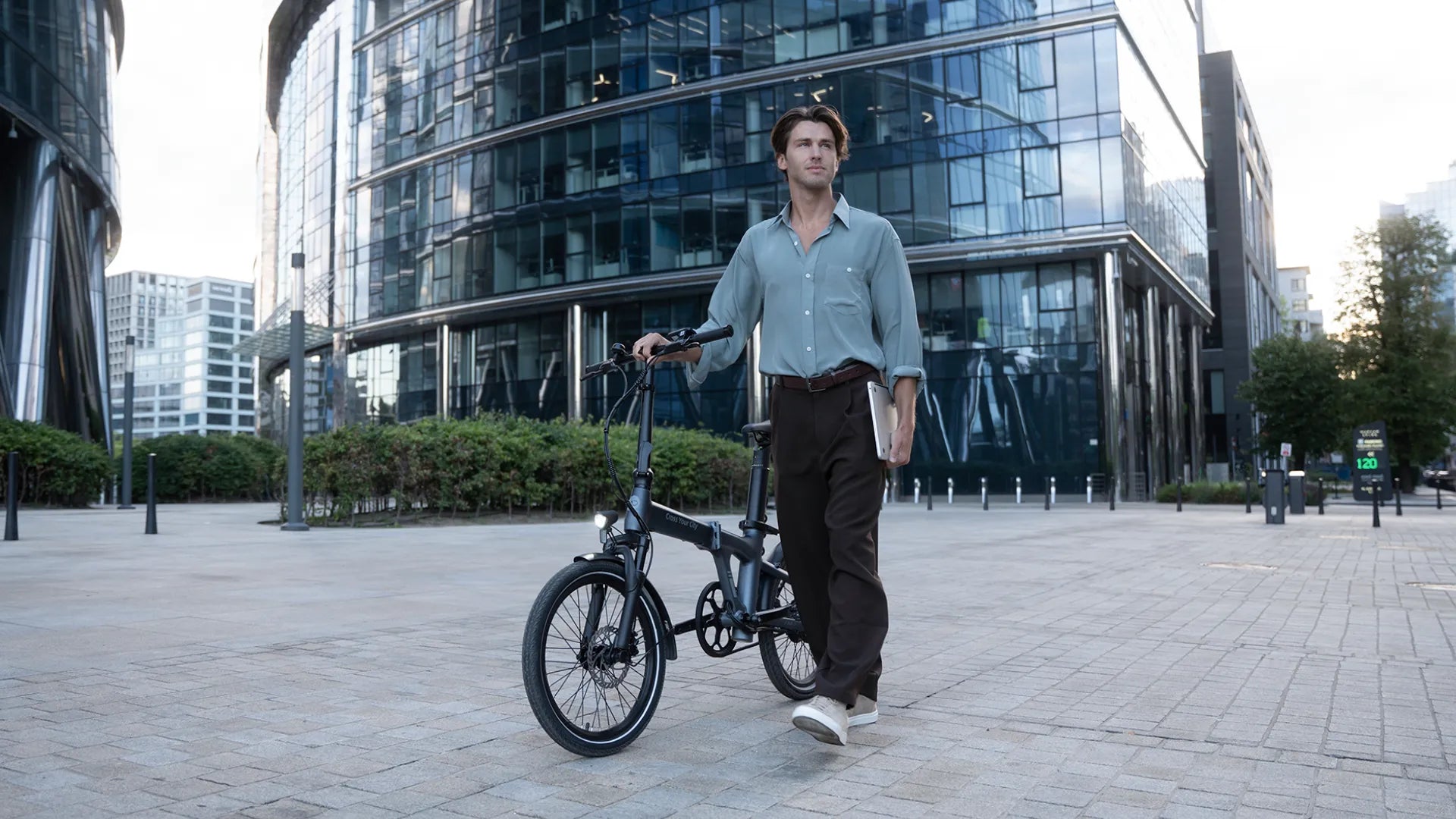ADO Air 20S 2026 folding e-bike with a commuter in a modern office district